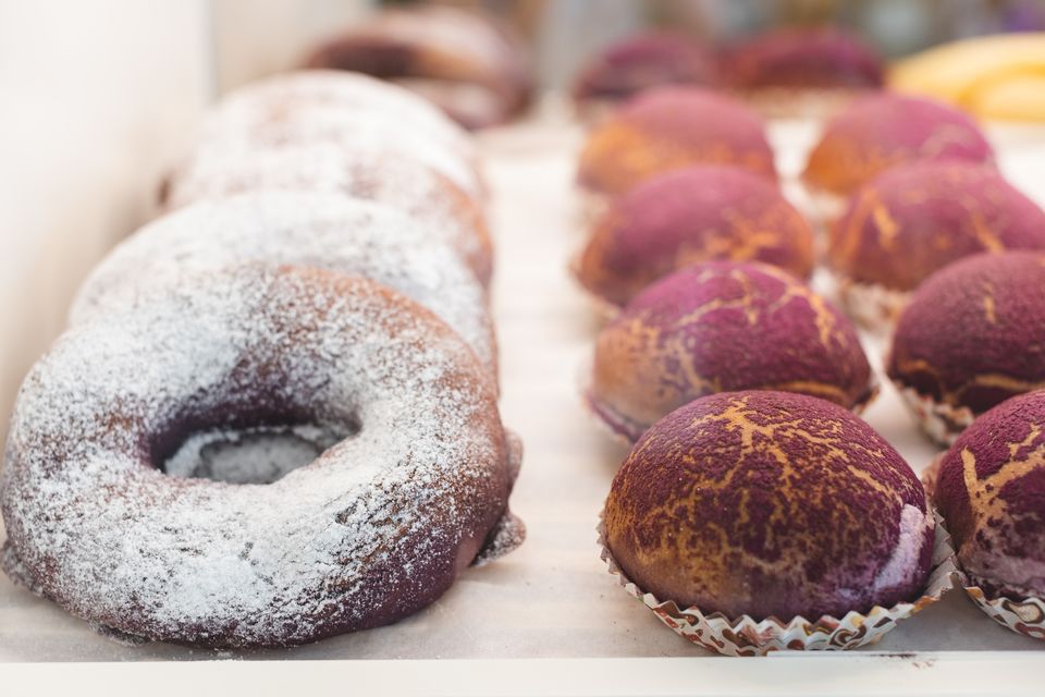 Sugar-dusted donut and ube pastries on display