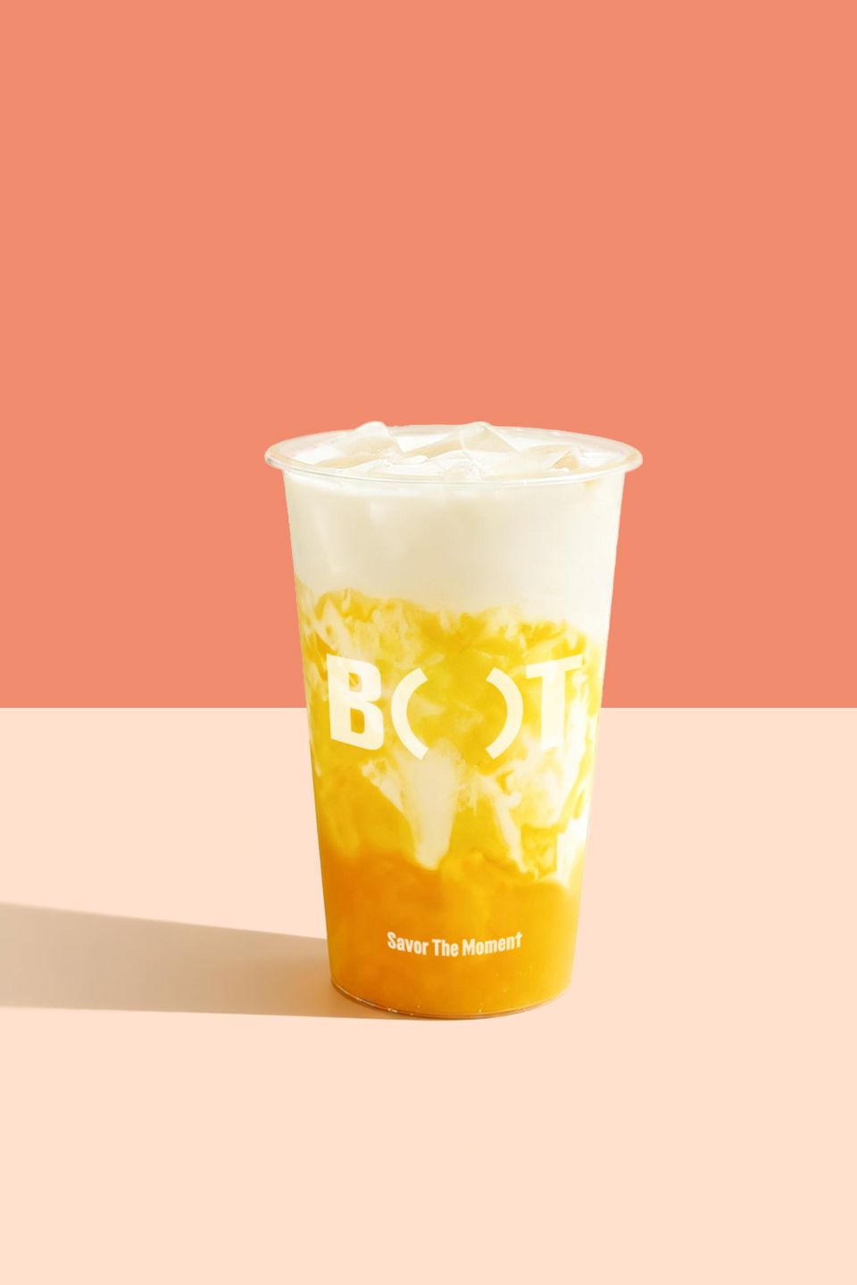 Iced mango milk tea with a creamy topping