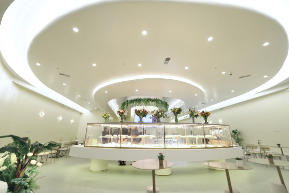 Dessert display counter under a sculpted ceiling